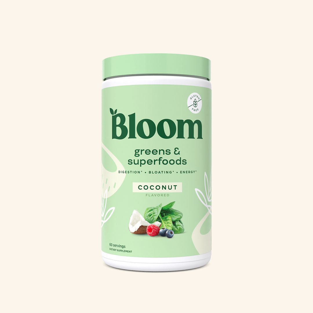 A container of Bloom greens & superfoods powder in Coconut flavor, labeled as supporting digestion, bloating, and energy. 60 scoop servings.